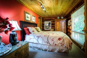 a bedroom with a bed and a wooden ceiling at Shambhala Bed and Breakfast in Buckhorn