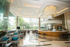 een lobby van een hotel met een bar en stoelen bij The Mira Central Park Hotel in Bien Hoa