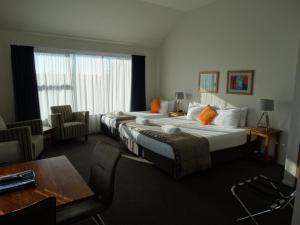 En eller flere senge i et værelse på Alpine Glacier Motel