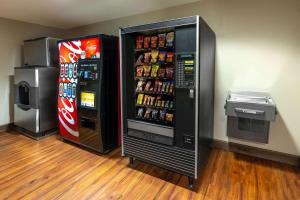 two soda machines are sitting next to each other at Microtel Inn & Suites in Raton