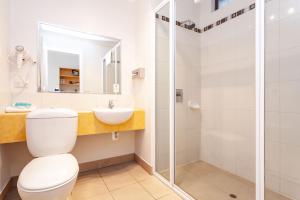 a bathroom with a toilet, sink, and shower at Beachfront Bicheno in Bicheno