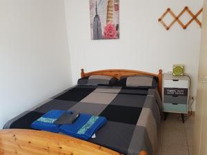 a bedroom with a bed with a checkered bedspread at Sweet Apartment Bianchini in Bologna