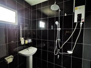 a black tiled bathroom with a shower and a sink at The Chill Town Home in Maha Sarakham +66 photos