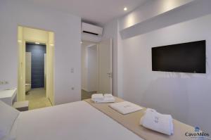 A bed or beds in a room at Cavo Milos