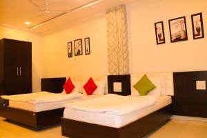 Voodi või voodid majutusasutuse Hotel Neem Tree toas