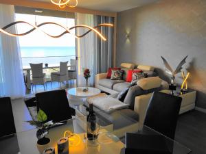 a living room with a couch and a table at Madeira Mar - Seaview in Funchal