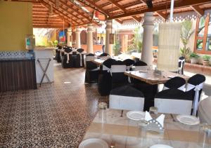 a dining room with tables and chairs in a restaurant at Tangerine Boutique Resort in Calangute