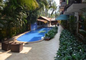 a swimming pool in the middle of a building at Tangerine Boutique Resort in Calangute