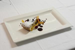 a white plate with a piece of cake on it at Albergo Morandi in Valbondione