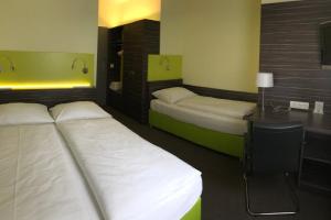 Voodi või voodid majutusasutuse Behringers City Hotel Nürnberg toas