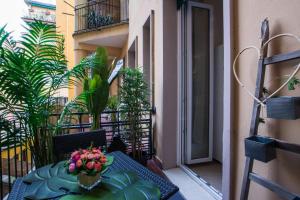 a table with a vase of flowers on a balcony at La Dotta Apartments in Bologna
