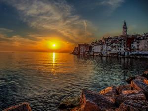 a sunset over the water with a city and the ocean at Heart of Town in Zadar