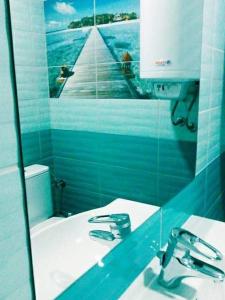 a bathroom with a mirror and a sink and a toilet at Деси Къща за гости 1 in Chernomorets +35 photos