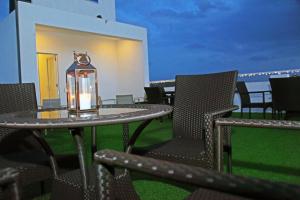 a patio with a table and chairs and a lantern at The Suite 262 in Negombo