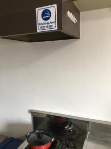 a kitchen counter with a box on top of a stove at コンドミニアムホテル Stay inn Blue in Hukue