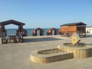 a park with benches and huts on the beach at Caspian Star in Sumqayıt