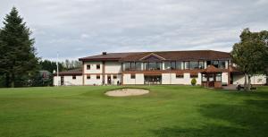 a large building with a putting green in front of it at Taigh d'Luxe in Inverness