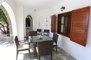 a dining room with a table and chairs at Seaside 2 in Agia Paraskevi