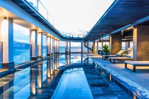 an infinity pool on the top of a building at Stella Maris Beach Danang in Da Nang