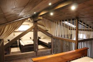a attic room with two beds and a staircase at Apartma Skednj in Kobarid