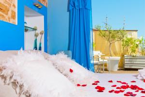 a bed with a white comforter with red flowers on it at Cas Ferrer Nou Hotelet in Alcudia