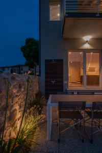 einen Tisch und Stühle vor einem Haus in der Unterkunft La Bellavita del Garda Luxury Apartments in San Felice del Benaco
