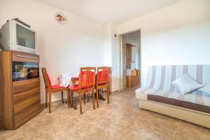 a bedroom with a table and chairs and a bed at Marijan in Pula
