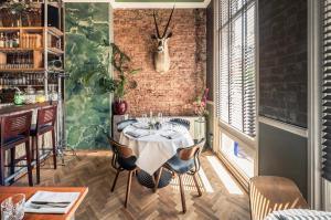 une salle à manger avec une table et un mur en briques dans l'établissement Hotel Sleep-Inn Box 5, à Nimègue