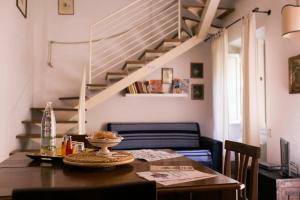 uma sala de jantar com uma mesa e uma escada em Relais Sassetti em Pisa