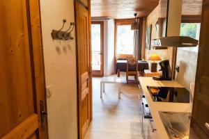 a kitchen and living room in a tiny house at Studio Panorama - Vue montagne et village, Centre la Clusaz - AravisTour in La Clusaz +4 photos