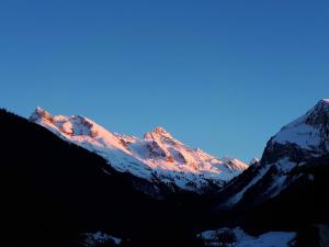 a view of a snow covered mountain at sunset at L'Ancolie in Le Reposoir
