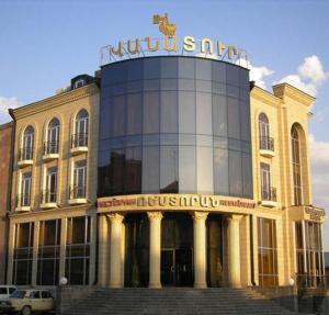 a building with a sign on top of it at Vanatur Hotel in Gyumri