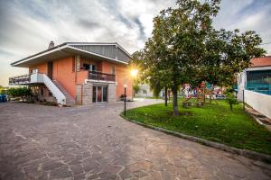 a building with a tree in front of it at Coltura in Termoli