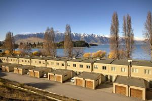 a row of buildings next to a body of water at Esplanade Queenstown by Staysouth in Queenstown
