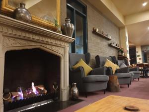 a living room filled with furniture and a fire place at Madison Spa Motel - Adults Only in Moama
