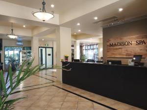 a lobby of a madison spa with a counter at Madison Spa Motel - Adults Only in Moama