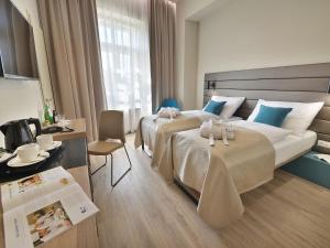 Postel nebo postele na pokoji v ubytování EA Hotel New Town + 37 fotografií