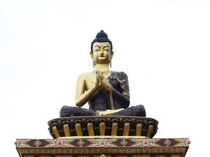 a statue of a buddha sitting on a throne at Yangthang Dzimkha Resort in Pelling