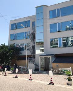 a building with red and white cones in front of it at Sun N Blue Hotel in Sarandë