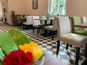 a restaurant with tables and chairs and flowers on the table at LOK - Die Pension - Das Restaurant in Tessin