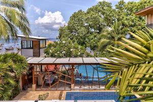 a resort with a pool and a deck with a view at Sairee Hut Resort Koh Tao in Ko Tao