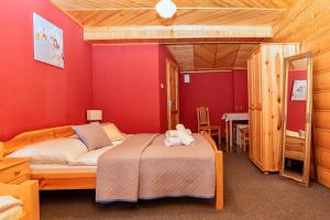 a bedroom with a bed with a teddy bear on it at Privát U Mara in Poprad +68 photos