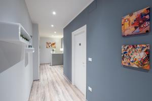 a hallway with blue walls and a painting on the wall at HOME52 in Rende