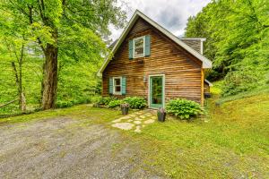 a wooden house with a driveway in front of it at Sugarbush River Home in Warren
