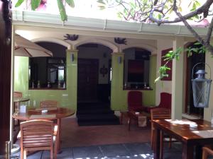 a restaurant with tables and chairs and a door at Sala Boutique Hotel in Male City