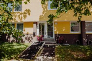 a dog standing in front of a house at Hamina City Apartments in Hamina