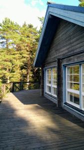 a house with two windows on a deck at Hevosniemi in Korppoo