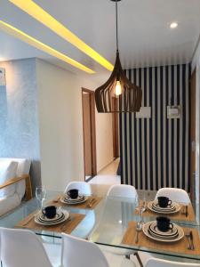 a dining room with a glass table and chairs at Palm Acqua Resort in Porto De Galinhas