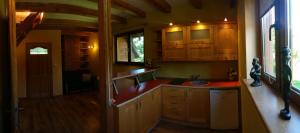 a kitchen with wooden cabinets and a sink at Agroturystyka Józefówka Borkowo Lęborskie in Zwartowko 