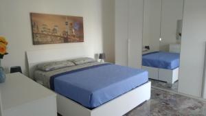 a bedroom with two beds and a mirror at Casa Vacanze Leo 2 in Acquarica del Capo